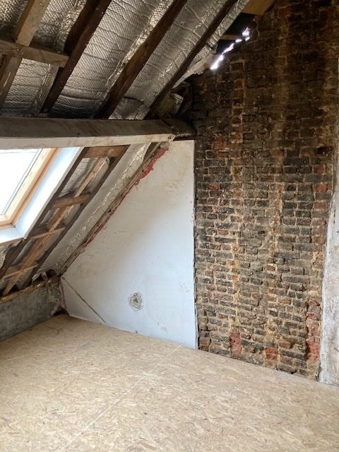 Grenier brut avec mur en briques avant rénovation - IDGS Constructions